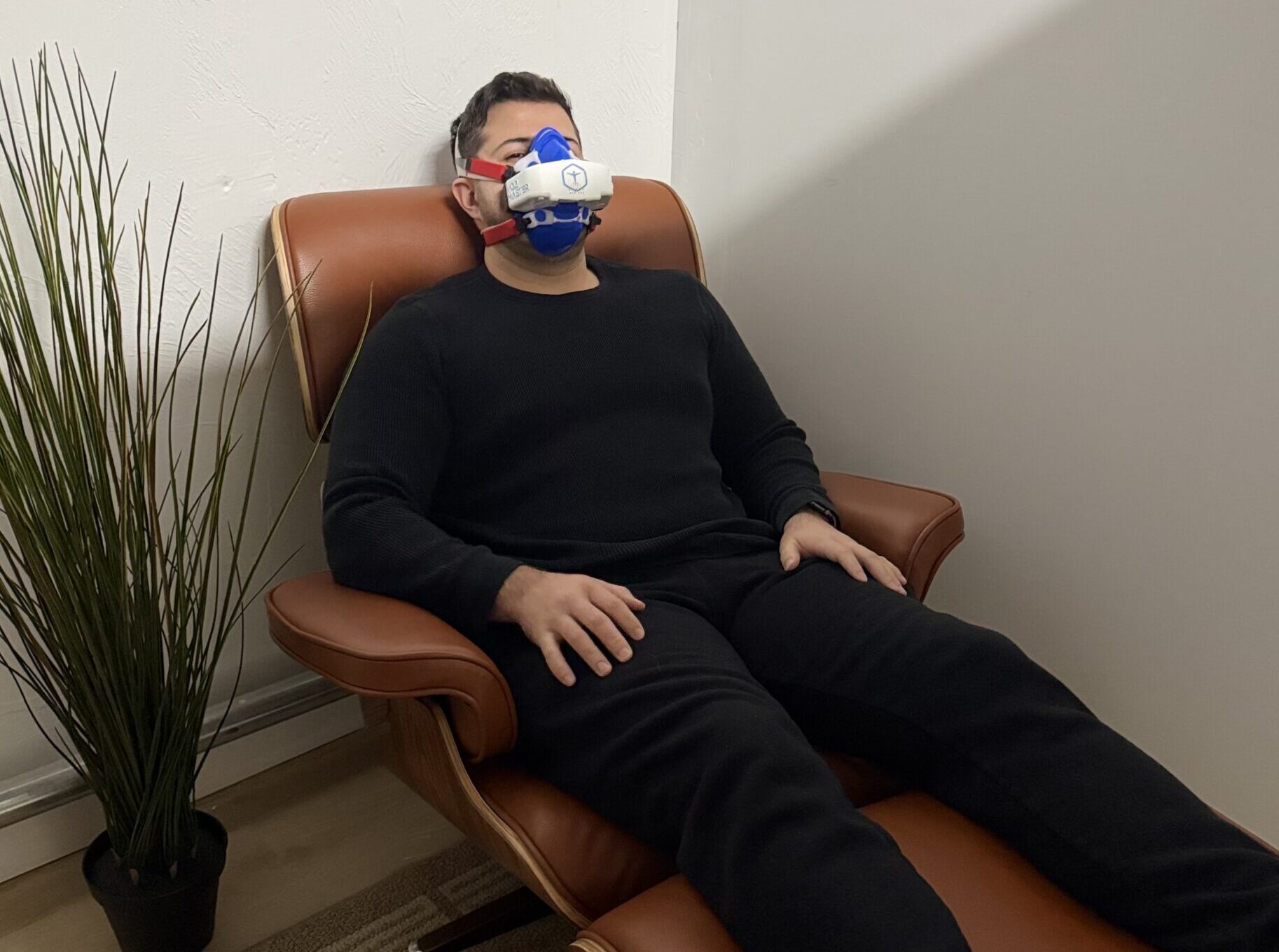 Client relaxing in the BodyStats RMR test chair wearing a VO2 Master metabolic measurement mask