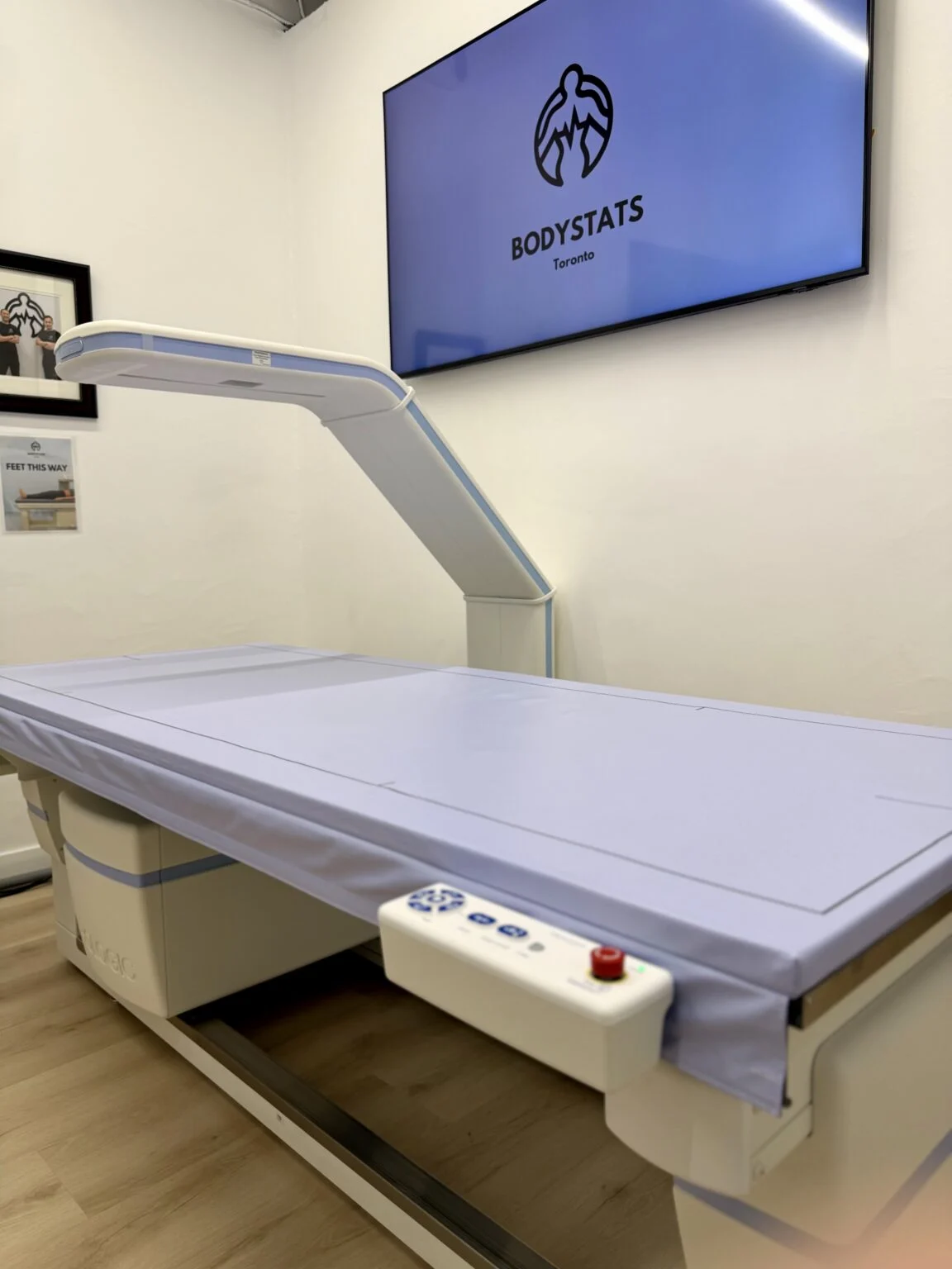 The Hologic DEXA scanner at BodyStats Toronto under the BodyStats Toronto screen