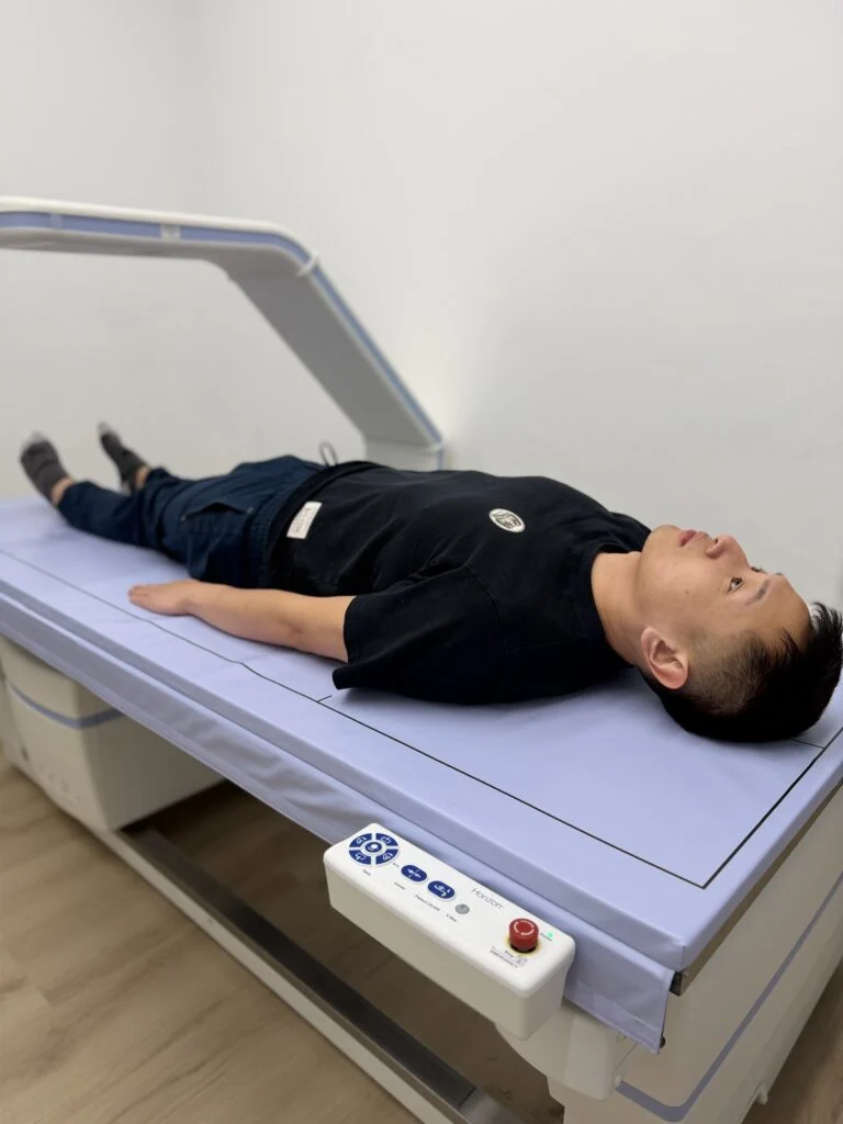Client lying on a BodyStats DEXA scanner
