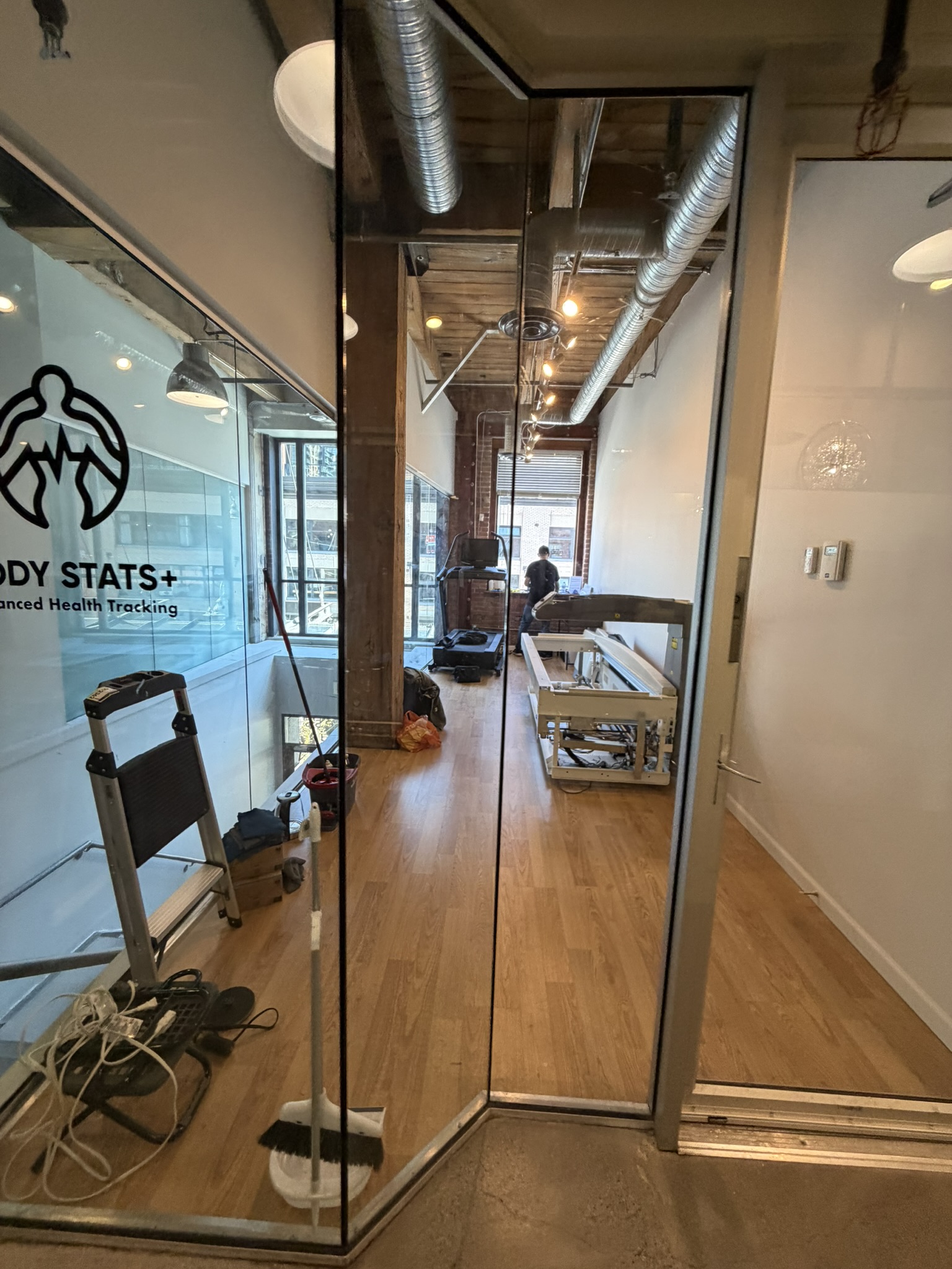 Treadmill and DEXA scanner inside the new BodyStats Yaletown studio with downtown view
