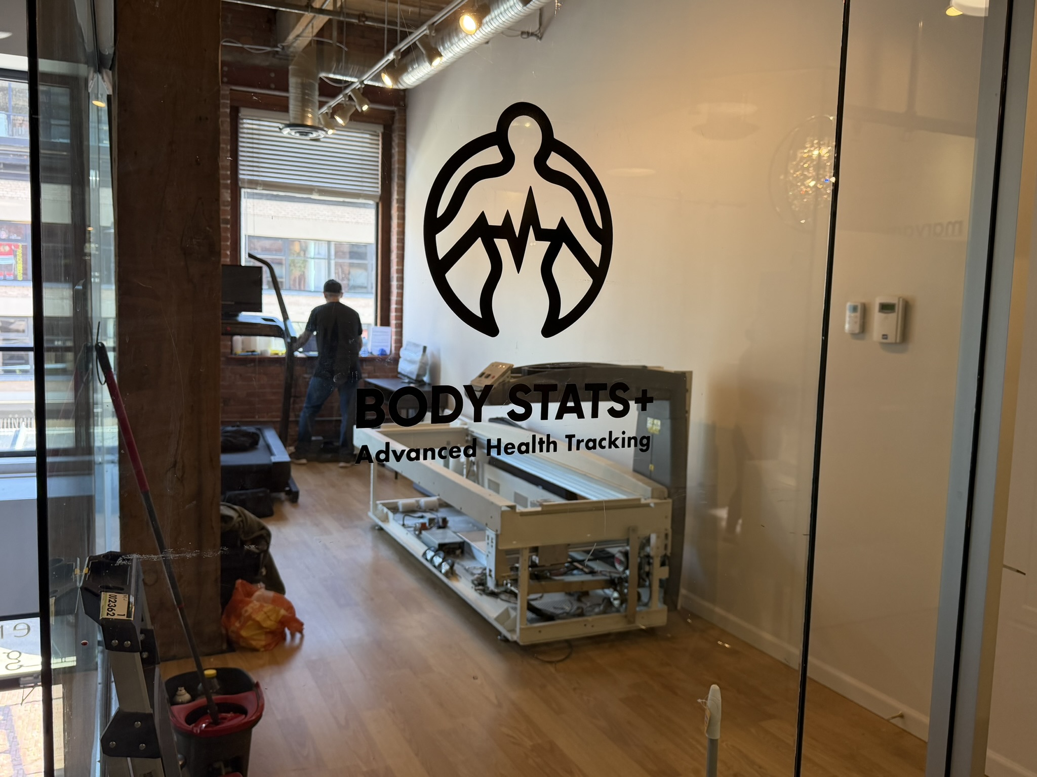 BodyStats logo and Advanced Health Tracking tagline on glass at the Yaletown studio
