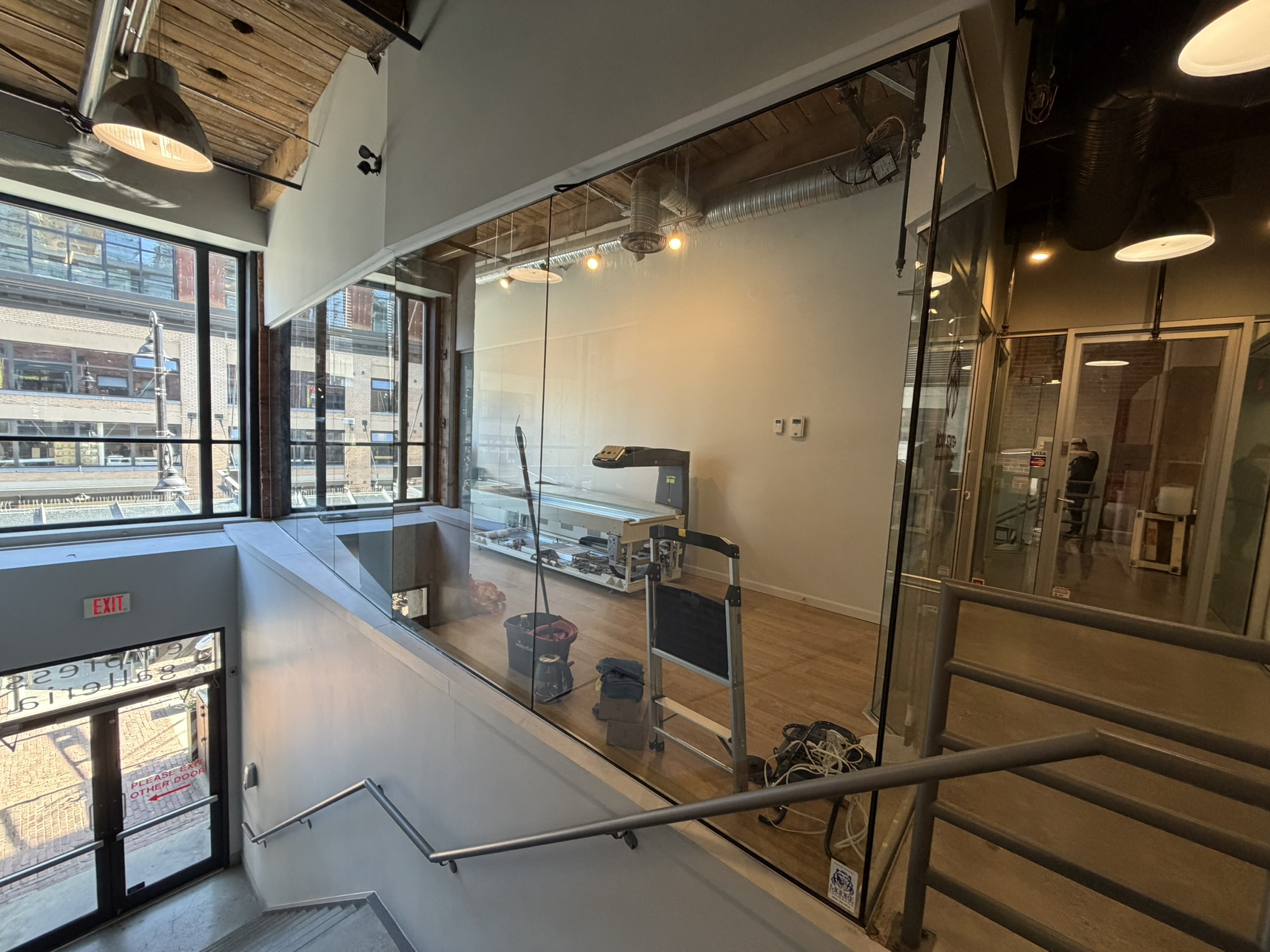 Mezzanine railing and glass partitions at the BodyStats Yaletown studio entry stair