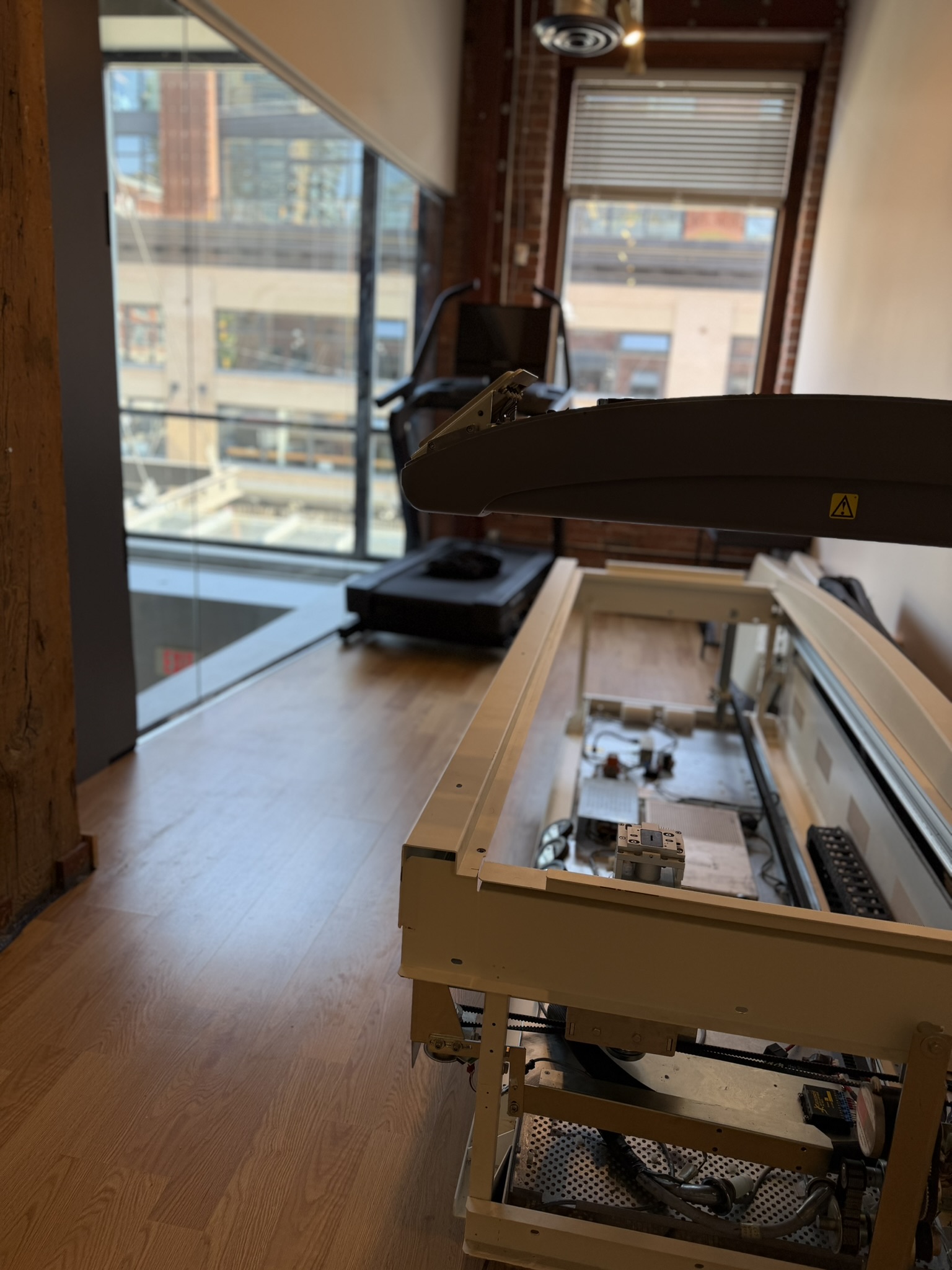 DEXA scanner with arm raised next to floor-to-ceiling windows at BodyStats Yaletown