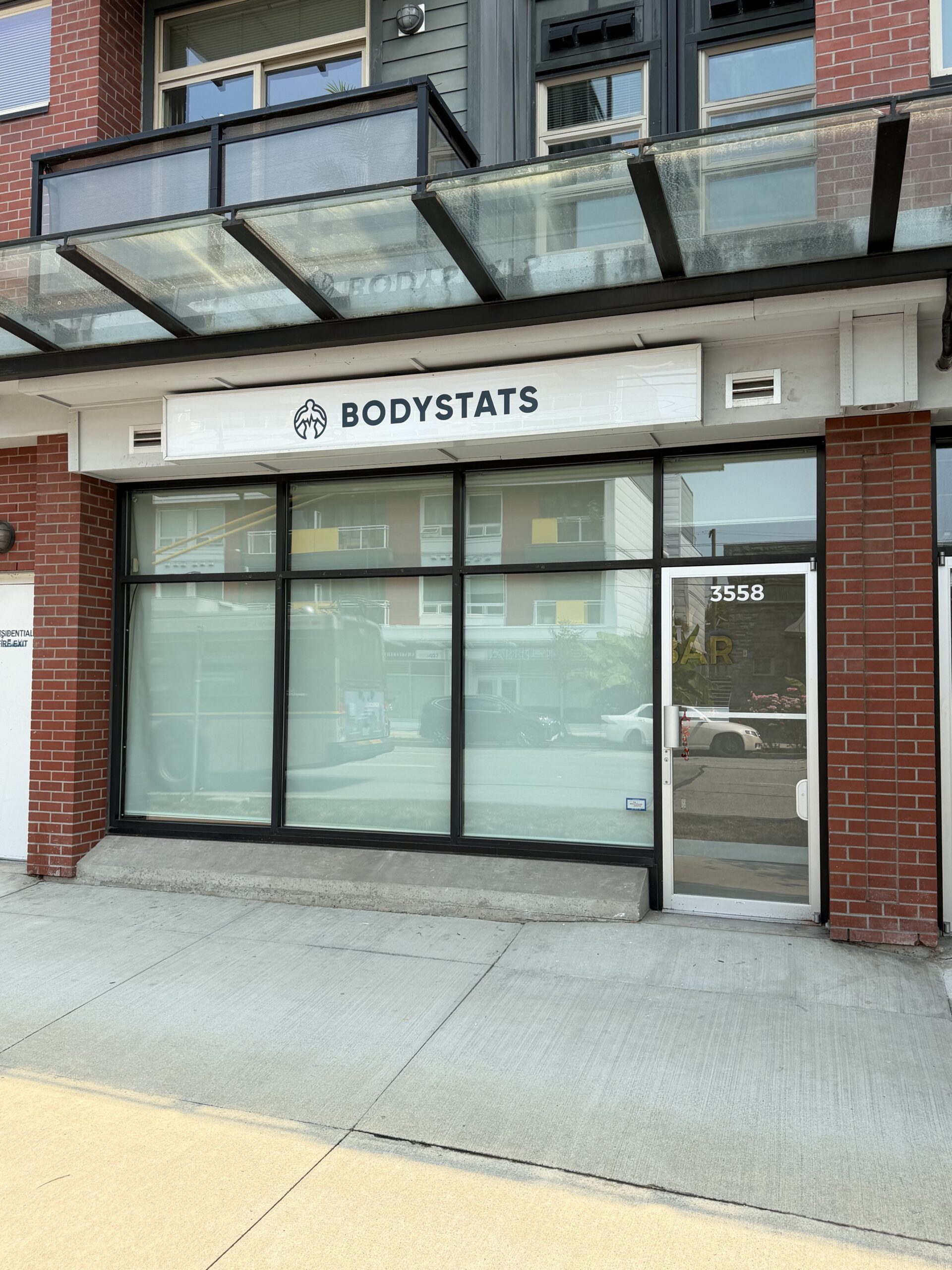 Daytime exterior of the BodyStats Fraser storefront at 3558 Fraser Street
