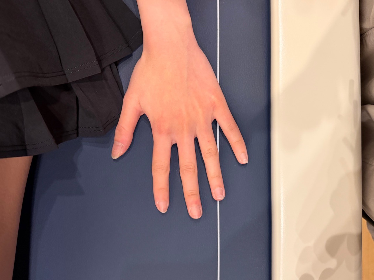 Client hand positioned beside the DEXA scan field at BodyStats Yaletown