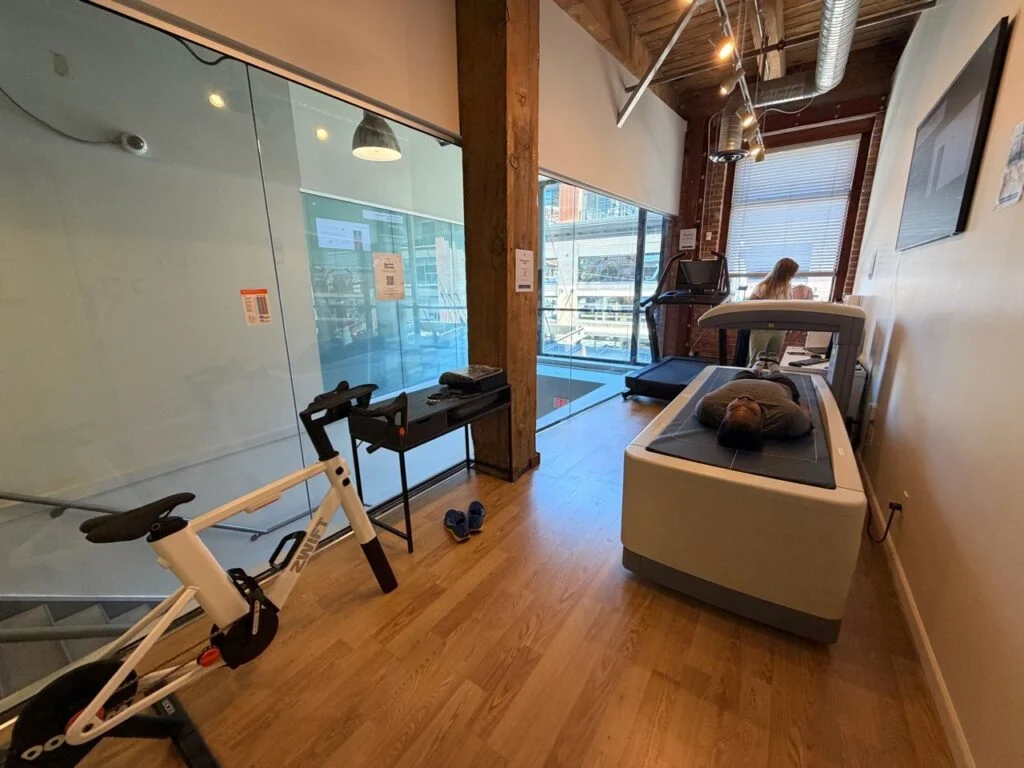Wide view of BodyStats Yaletown with the DEXA scanner and treadmill