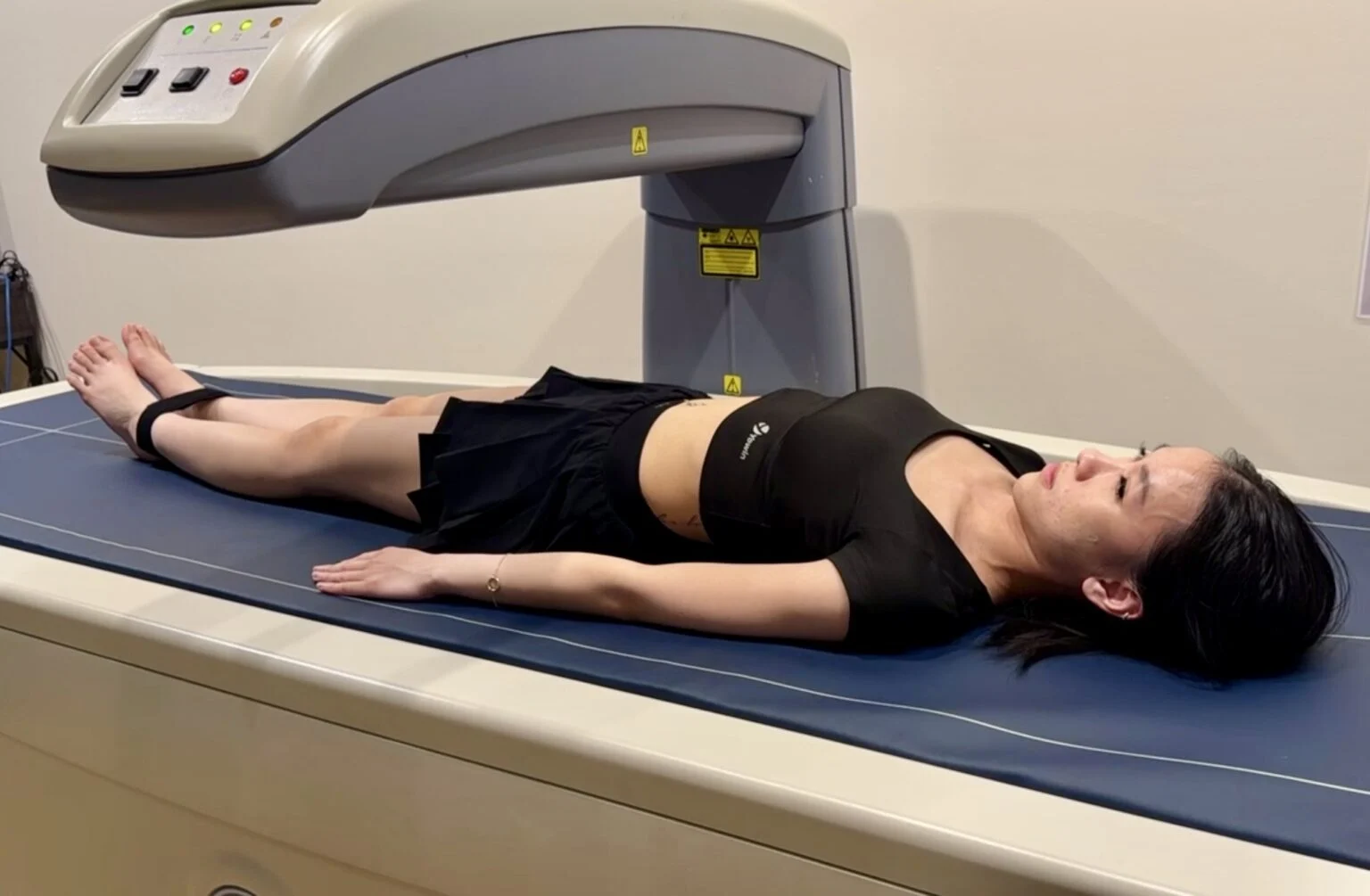 Client lying on a DEXA scanner at BodyStats