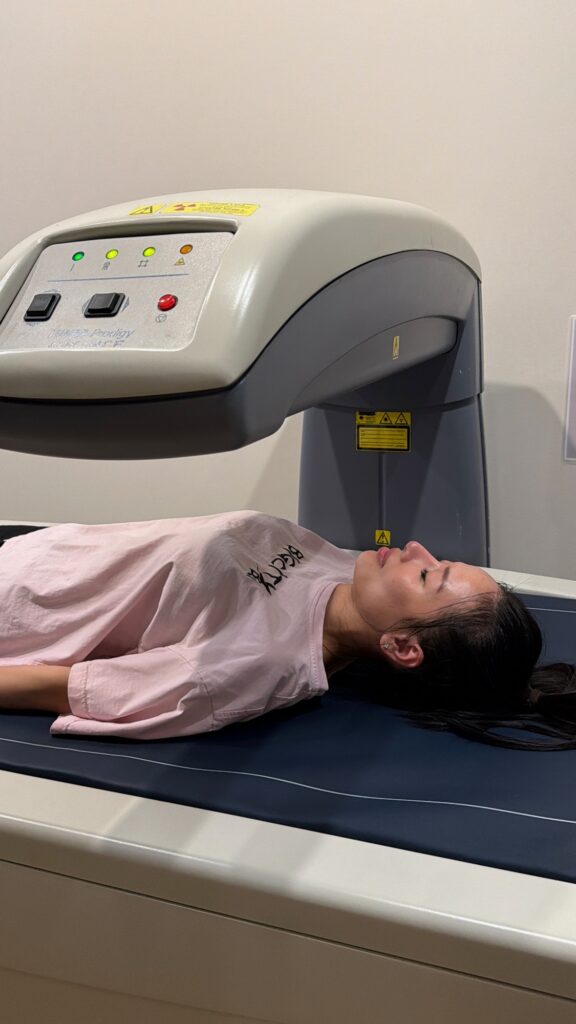 Client relaxing during a DEXA body composition scan at BodyStats Yaletown