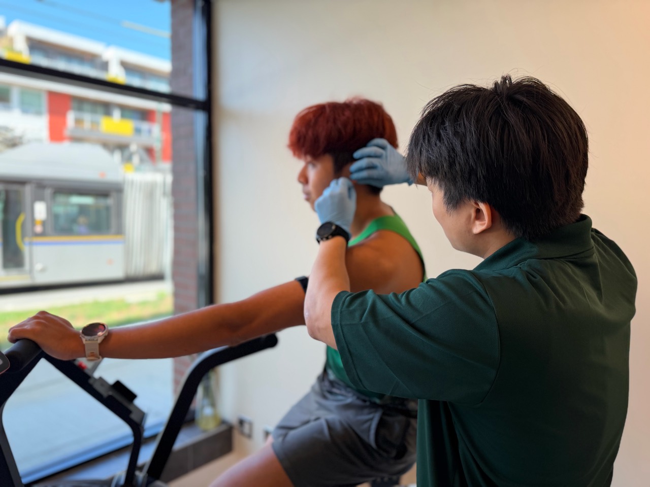 A BodyStats team member taking an earlobe blood sample